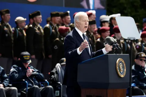 Benoit Tessier/AFP US President Joe Biden delivers a speech, as US WWII veterans look on during the US ceremony marking the 80th anniversary of the World War II 