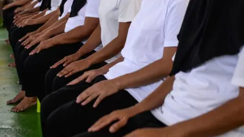 Getty Images Female prisoners granted royal pardon attend a ceremony at the Narathiwat provincial jail in Thailand's southern province of Narathiwat