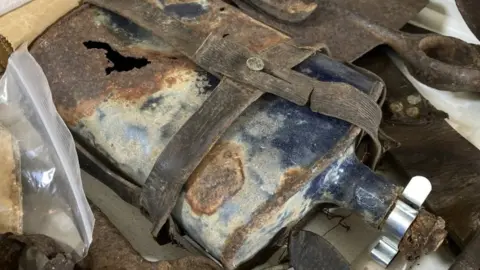 Martin Giles/BBC A flask in its leather casing, among items found with L/Sgt Charles Stevens' body in France
