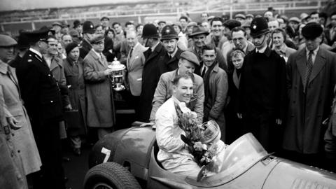 Sir Stirling Moss wins a race at Aintree in 1954