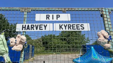 PA Media Floral tributes left to Kyrees Sullivan and Harvey Evans on Snowden Road, Ely, Cardiff following their deaths in a road accident. Picture date: Friday May 26, 2023