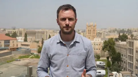 BBC journalist Joel Gunter in a blue shirt