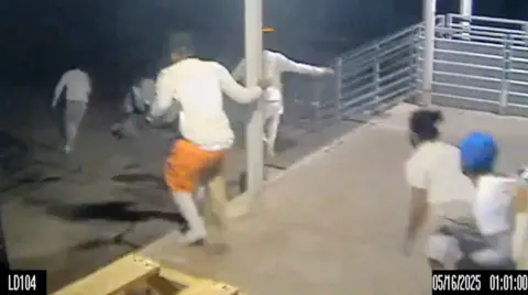 A screengrab taken from a handout of CCTV video shows inmates running through the loading dock at the Orleans Parish Jail