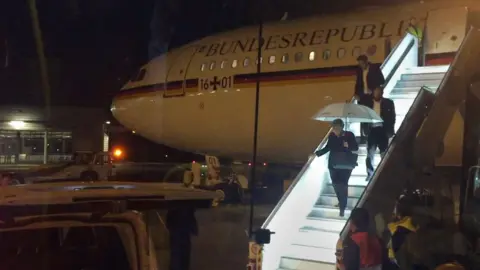 AFP German Chancellor Angela Merkel steps down from Airbus "Konrad Adenauer" on late November 29, 2018 on the tarmac of Cologne"s airport after an emergency landing