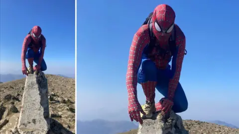 Dylan Hughes from Bangor dressed as Spider-Man atop Yr Wyddfa 