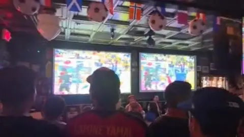 Supplied An inside view of a pub in America with football decorations and a number of screens showing the World Cup