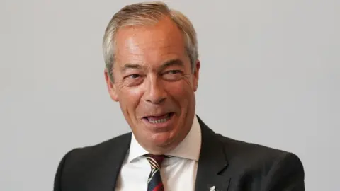 Reform UK leader Nigel Farage pictured laughing