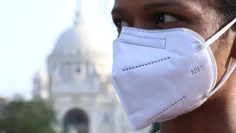 Getty Images Woman with mask on in Kolkata, India