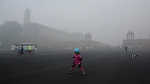 Getty Images Children doing skating in heavy smog near the president house in New Delhi