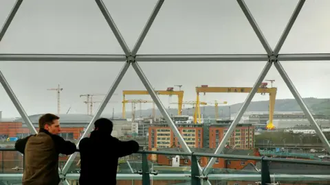 Getty Images Locals look at Belfast from the observation dome above the Victoria Square shopping development