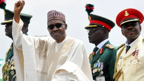 Getty Images Nigerian President Muhammadu Buhari (2-L) waves to supporters during his inauguration in Abuja, Nigeria 29 May 2015