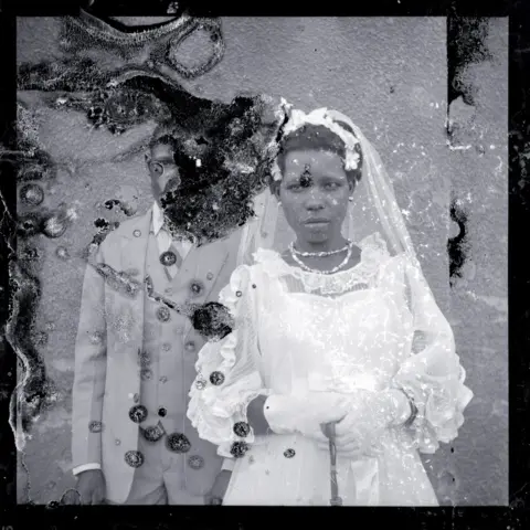 Ssalongo/Mwine Damaged wedding photograph