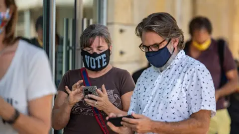 Sergio Flores Voters line up in Texas