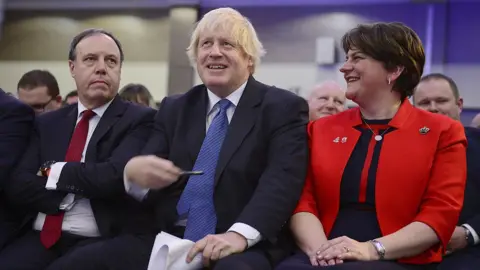 PAcemaker Boris Johnson, alongside Arlene Foster and Nigel Dodds, at the DUP party conference in 2018