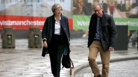 Reuters Theresa May and her husband Philip arriving in Manchester