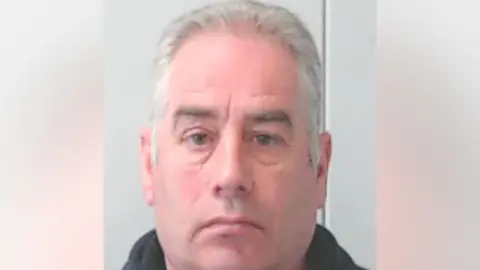 Police Scotland A police mugshot of convicted rapist Paul Patrick, a man in his early 60s with combed-back white hair
