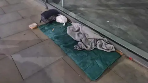 Sleeping bag and blanket on the street in Manchester city centre.