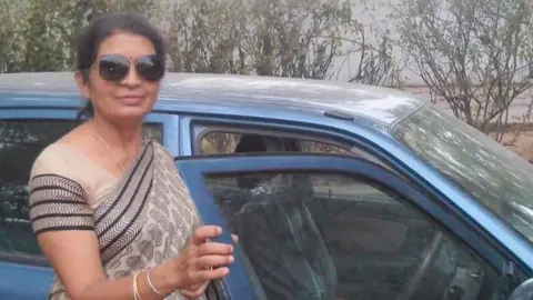 When India professor used chemistry as defence in murder trial but failed An Indian chemistry teacher called Mamta Pathak is wearing a sari, and standing outside a car in this undated picture.
