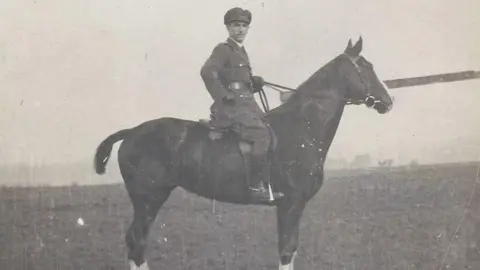 A black and white photograph of an officer on a war horse