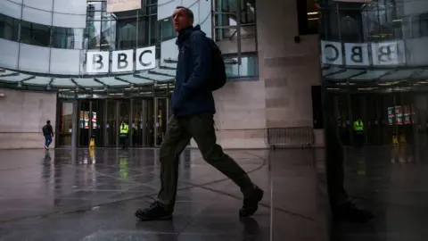 Reuters A man walking outside the BBC's New Broadcasting House in central London