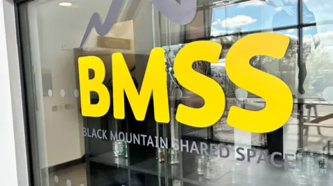 A glass window that says BMSS on it