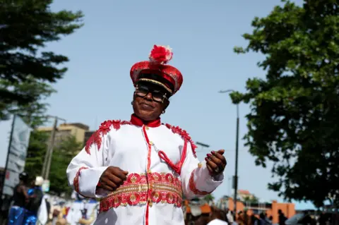 Reuters A woman in a red and white outfit poses for a photo