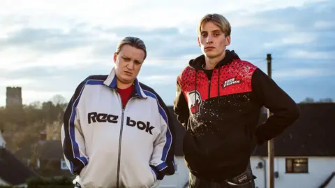 This Country : S2 E1 : Random Acts Of Kindness : 2018 - Picture shows Kurtan (Charlie Cooper) ; Kerry (Daisy May Cooper).