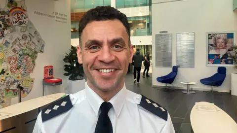 Photograph of DCI Chris Julien from Operation Vulcan. The image is taken inside the Greater Manchester Police force headquarters.
