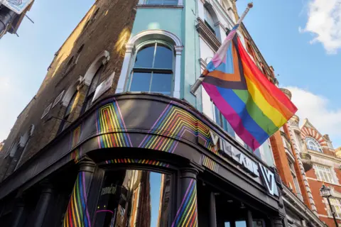 Getty Images A pride flag displayed above a Black Village sign