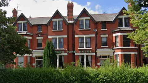 Google Image shows the Green Park Hotel in south Liverpool. It is a red-brick, three-storey early Edwardian building with trees in front of it and the words Green Park Hotel across the front. 