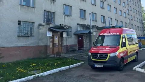 A Hungarian ambulance stands outside a Ukrainian hospital in Perechyn, Transcarpathia, April 2025