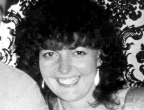 NNP A black-and-white picture of Janet Newton. She is smiling broadly and has darl curly hair.