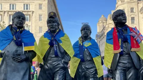 BBC Eurovision Beatles statue with Ukraine flags