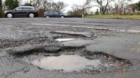 PA Pothole on a tarmac road
