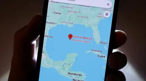 Getty Images A phone with Google Maps open. On the map we can see the Gulf of Mexico, as bordered by the US, Mexico and Cuba.