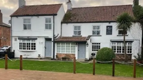 A closed village pub in Murton, near York. The building has two storeys and is whitewashed