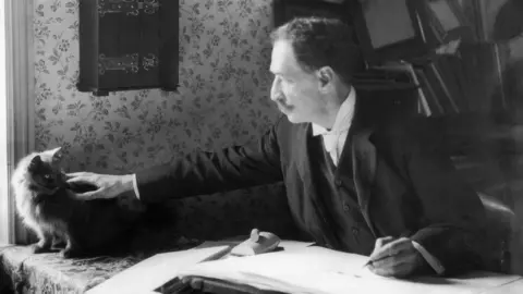 Getty Images Black and white image of Louis Wain with a cat
