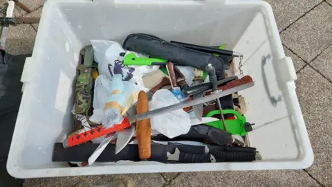 Essex Police A white box full of knives that have been handed in by members of the public