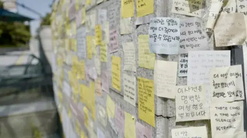 A note posted outside the subway station reads ‘how many more women need to die for this country to change?’