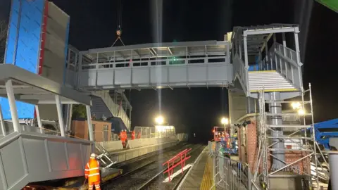 Network Rail Cranes lift footbridge into place