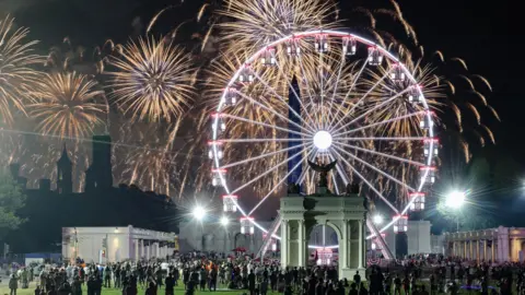 People watch a fireworks display that is attempting the largest firework display in history with 850,000 fireworks 