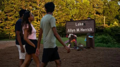 Getty Images People pass by a memorial to Laken Riley at Lake Allyn Herrick on the campus of the University of Georgia on June 7, 2024, in Athens, Georgia. On February 22, 2024,