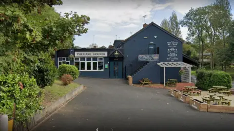 A large blue pub with the Hare and the Hounds sign on the front.