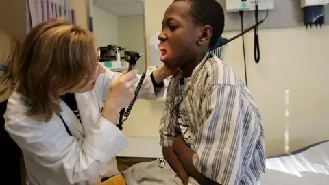 Joe Raedle/Getty A doctor and patient