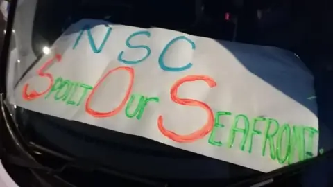 Save our Seafront Save our Seafront banner on a car dashboard