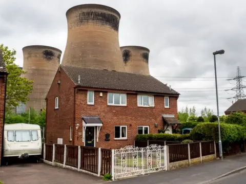 Peter Dench Houses situated in close proximity to the cooling towers at Ferrybridge Power Station. Knottingley, West Yorkshire.
