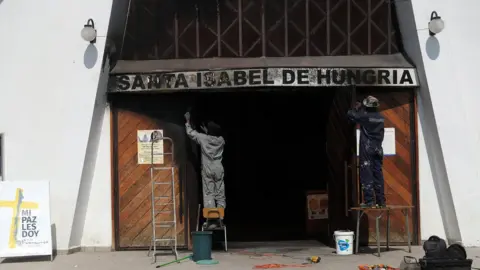 EPA People repair the church of St. Elizabeth of Hungary, where a fire was set on 12 January