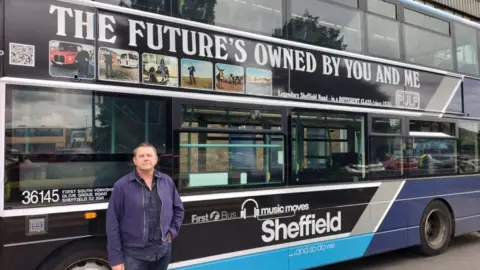 First South Yorkshire Pulp drummer Nick Banks with the branded bus