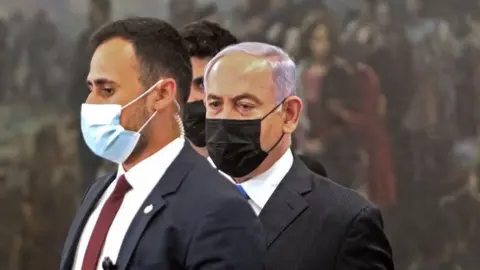 GIL COHEN-MAGEN/Getty Images Israeli PM Netanyahu arrives at the Knesset for debate and vote on government to replace him (13 June)