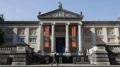 A man walks past the Ashmolean Museum in Oxford, southern central England, on April 24, 2020.